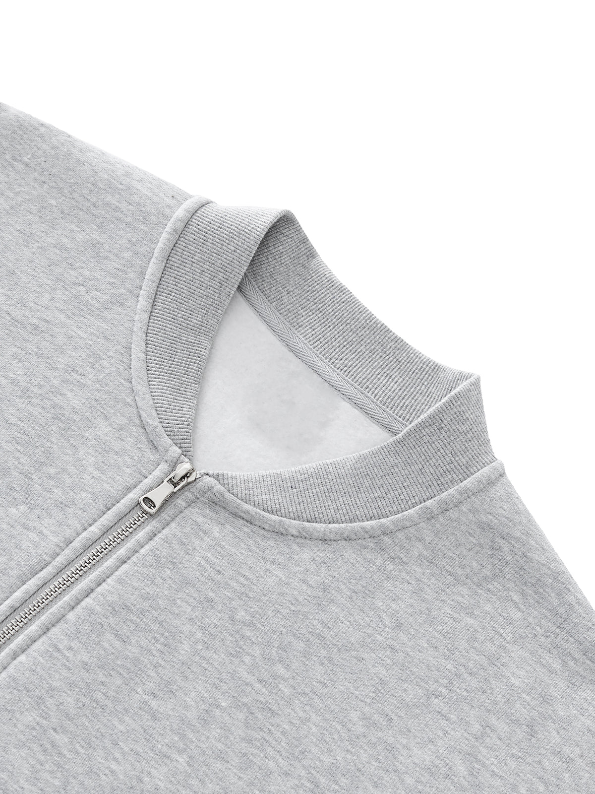 Close-up of a gray zip-up hoodie on a white background