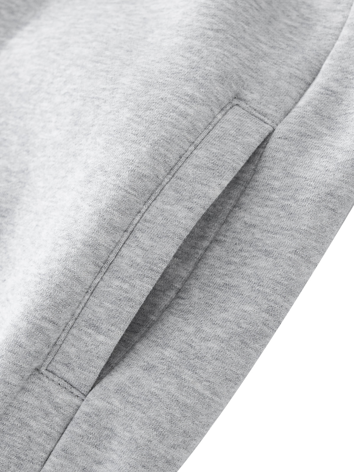 Close-up of gray fabric with a pocket detail on a white background