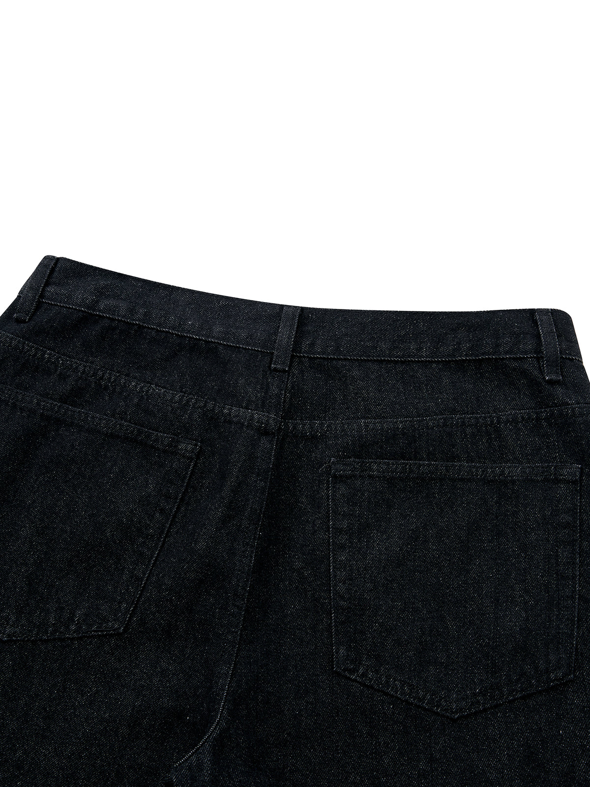 Close-up of the back waistband and right rear pocket of black denim jeans against a plain white background.