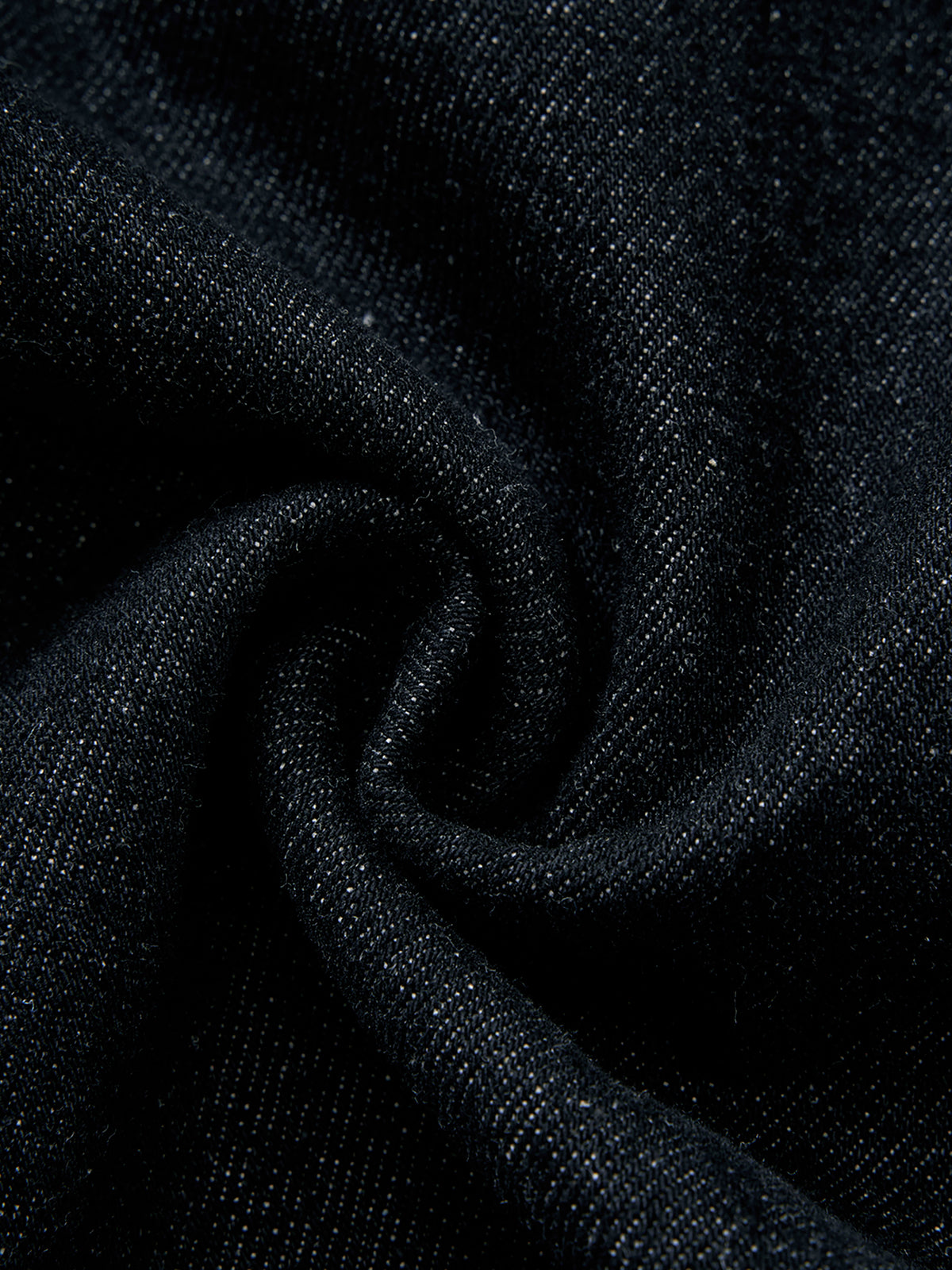 A close-up of dark charcoal gray textured fabric with a subtle woven pattern, arranged in a soft spiral drape.