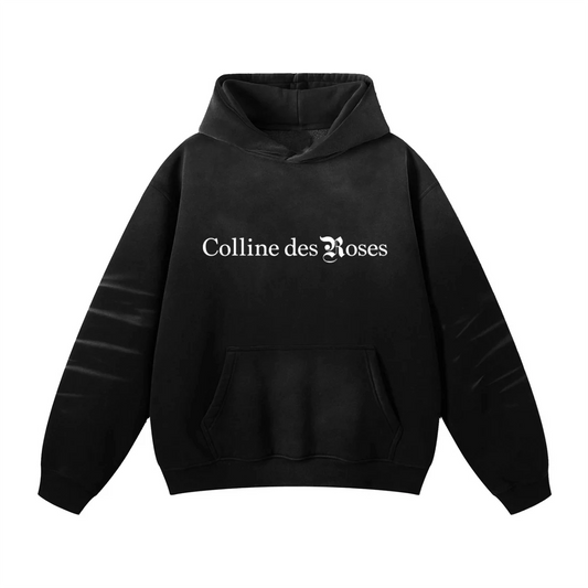 Black hoodie with 'Colline des Roses' text on a white background