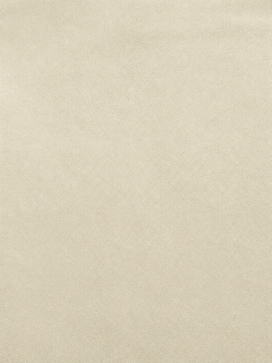 A close-up of a light beige textured fabric surface filling the frame.