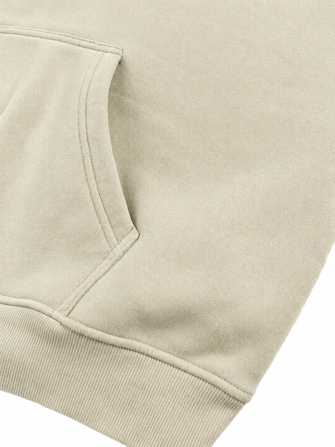 Close-up of a light beige or cream-colored sweatshirt showing the texture of the fabric and the edge of a front kangaroo pocket.