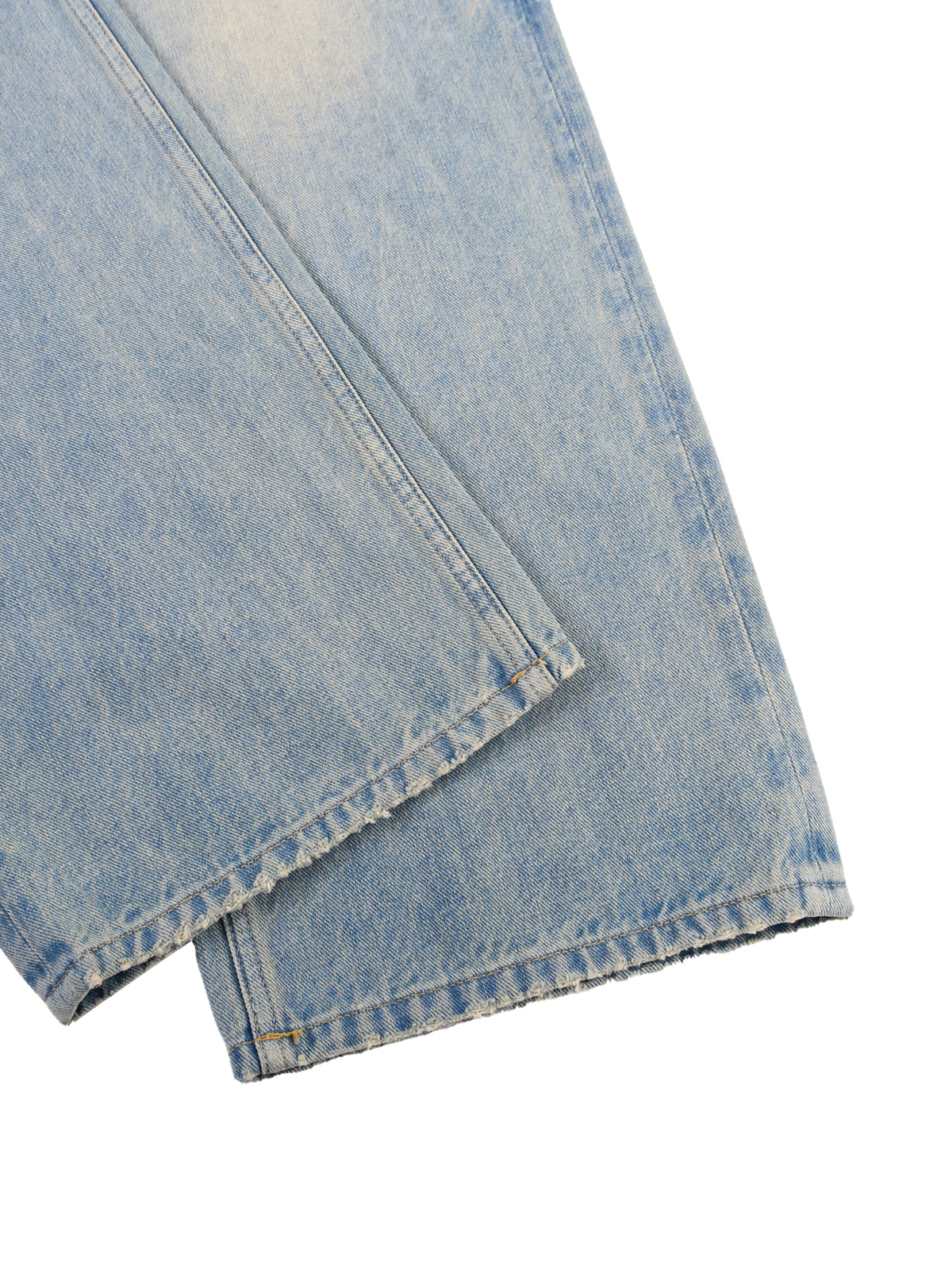 Close-up of light blue denim fabric on a white background
