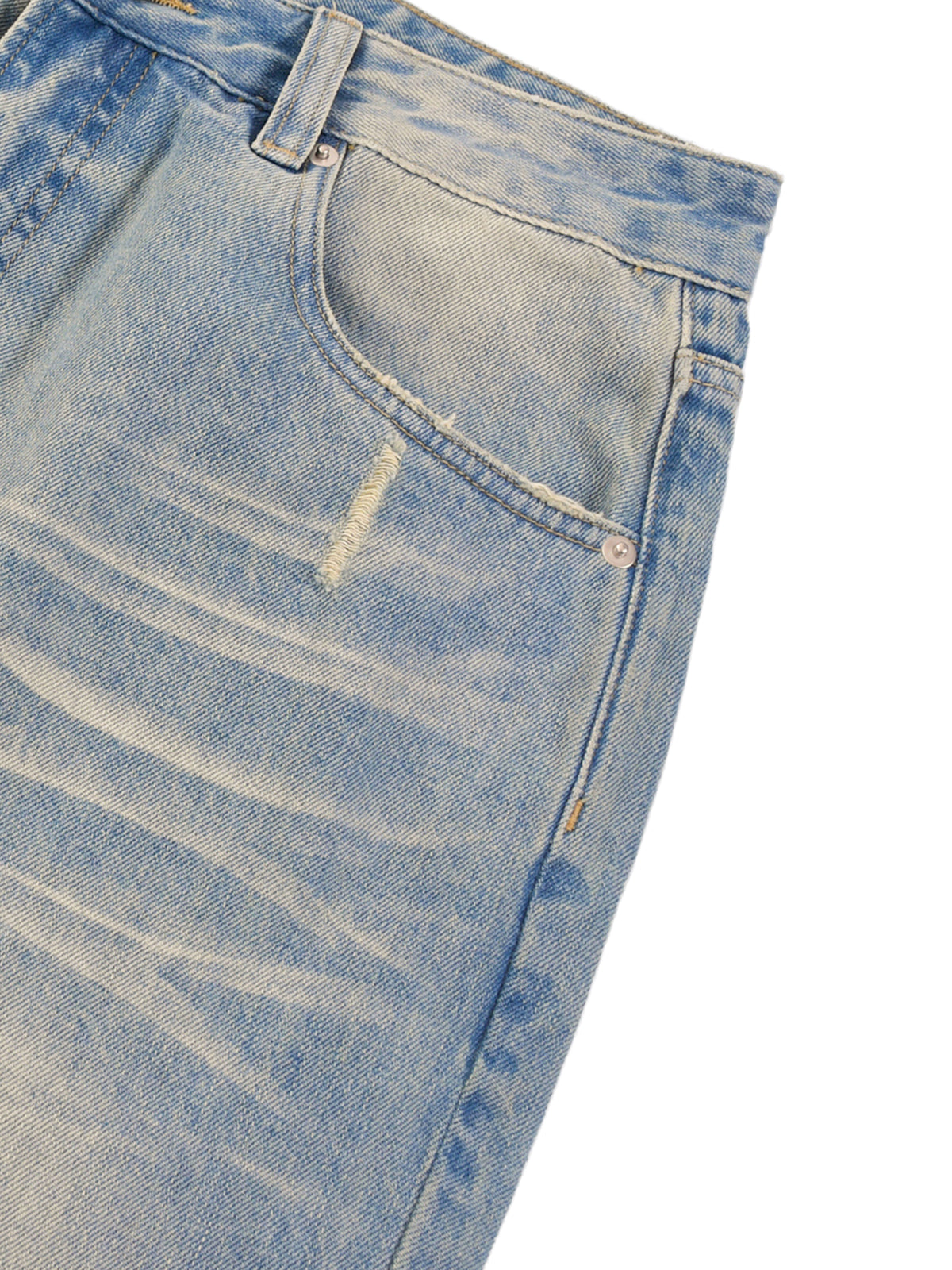 Close-up of a pair of light blue jeans with visible distressing on a white background
