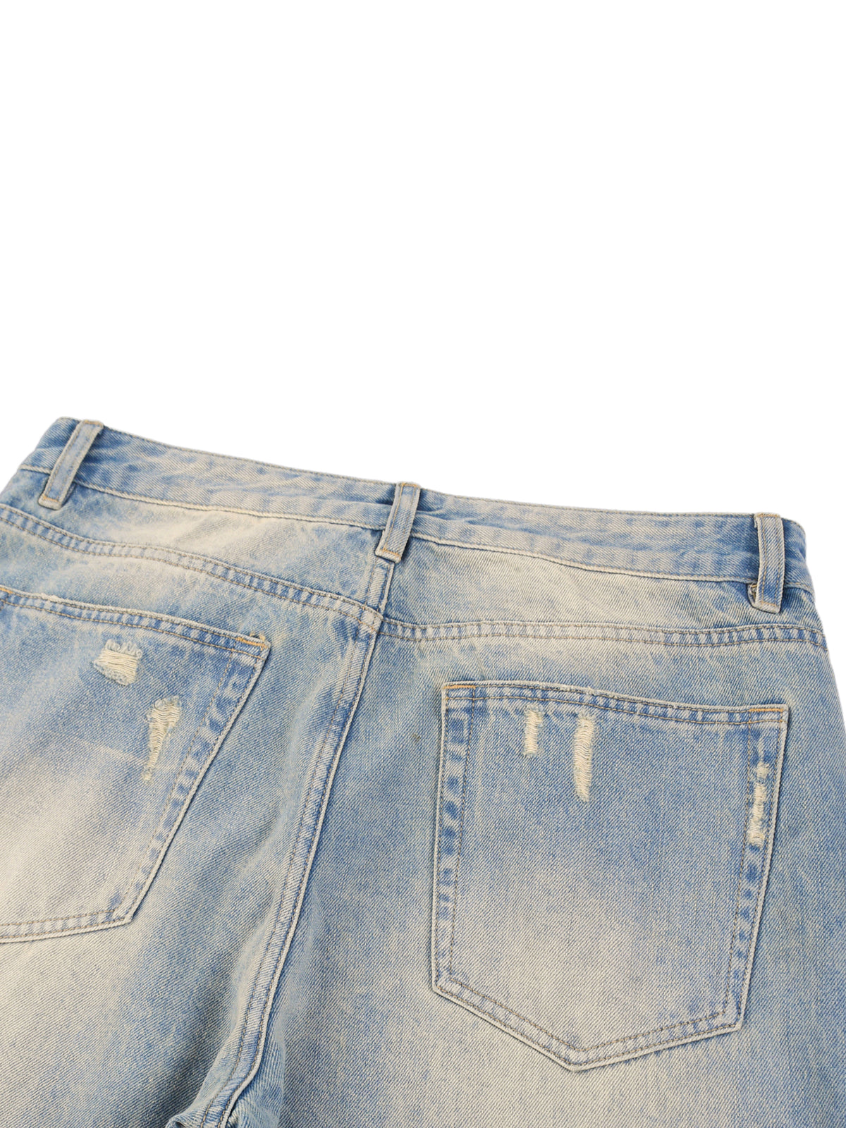 Close-up of a pair of light blue denim jeans with slight distressing on a white background