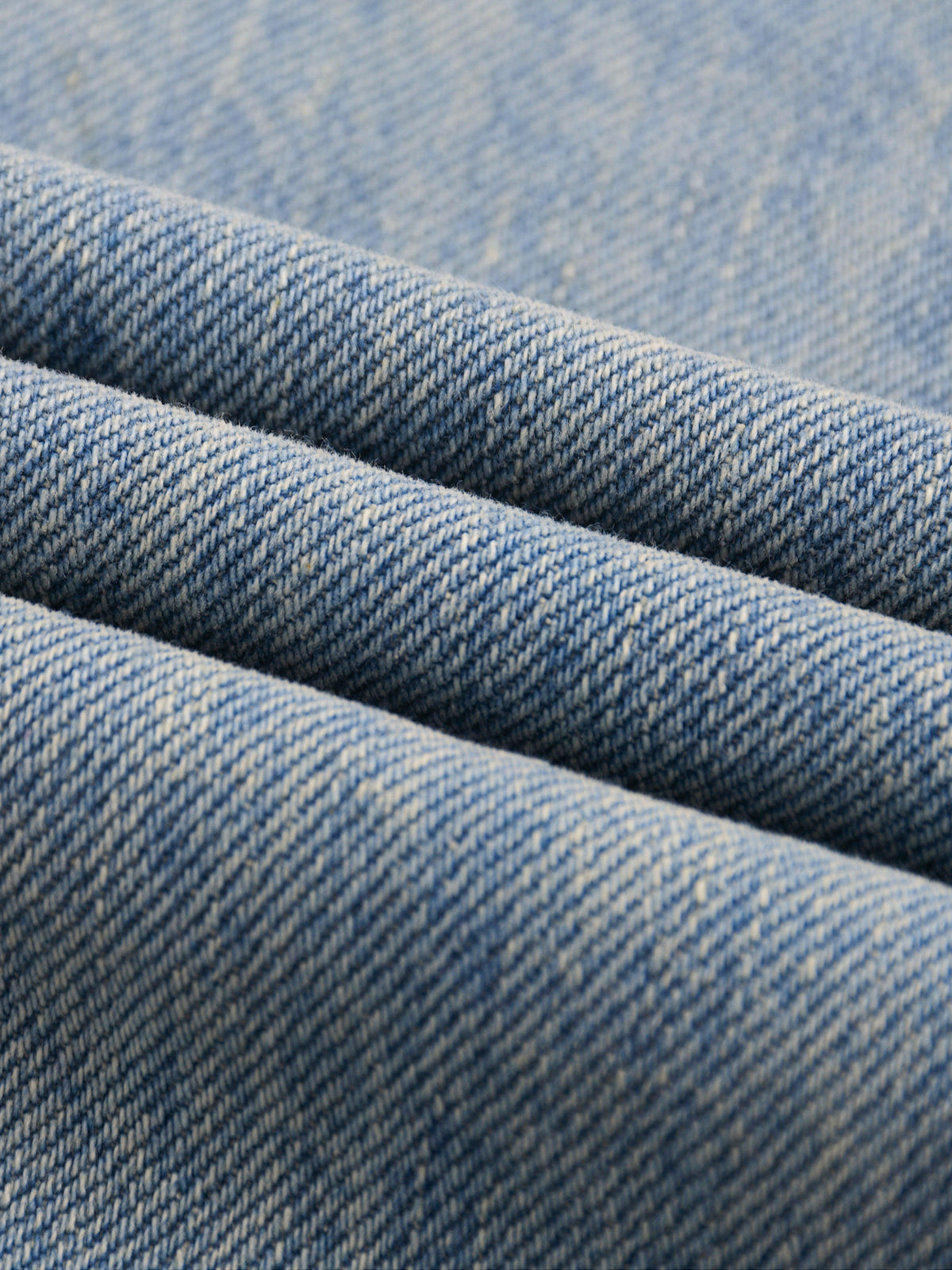 Close-up of blue denim fabric with a subtle pattern