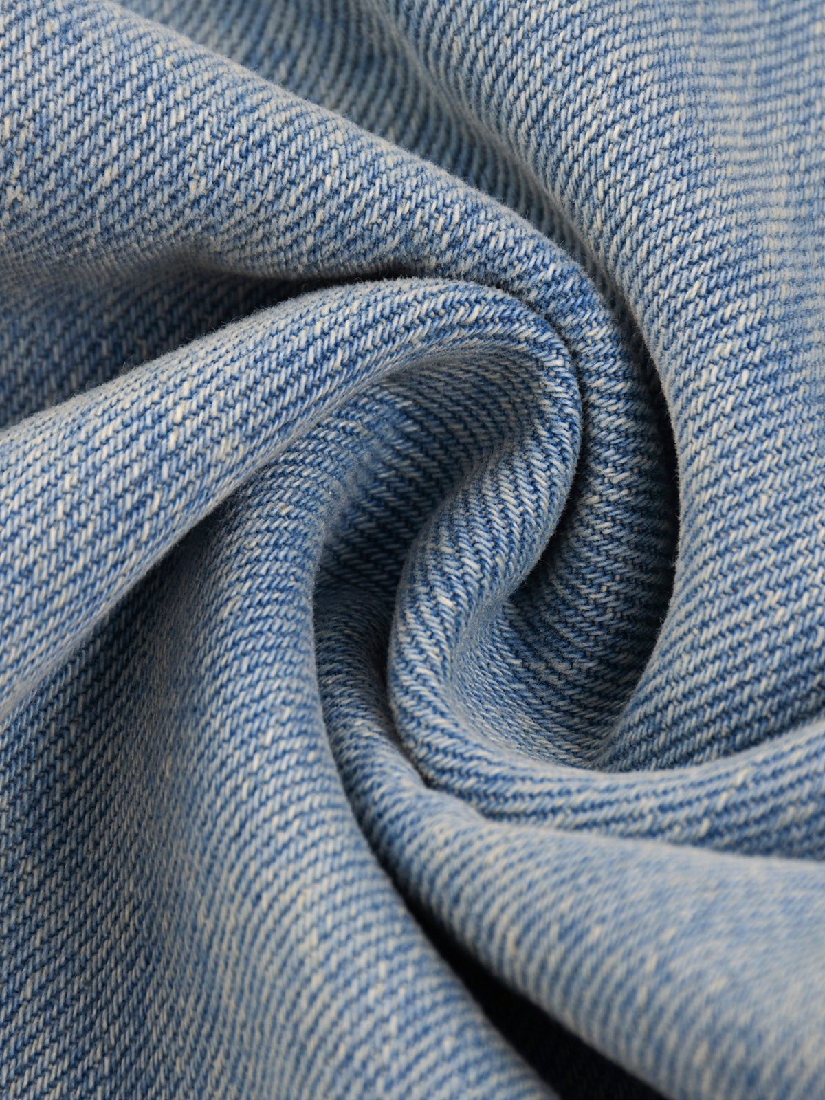 Close-up of blue denim fabric with a swirl pattern