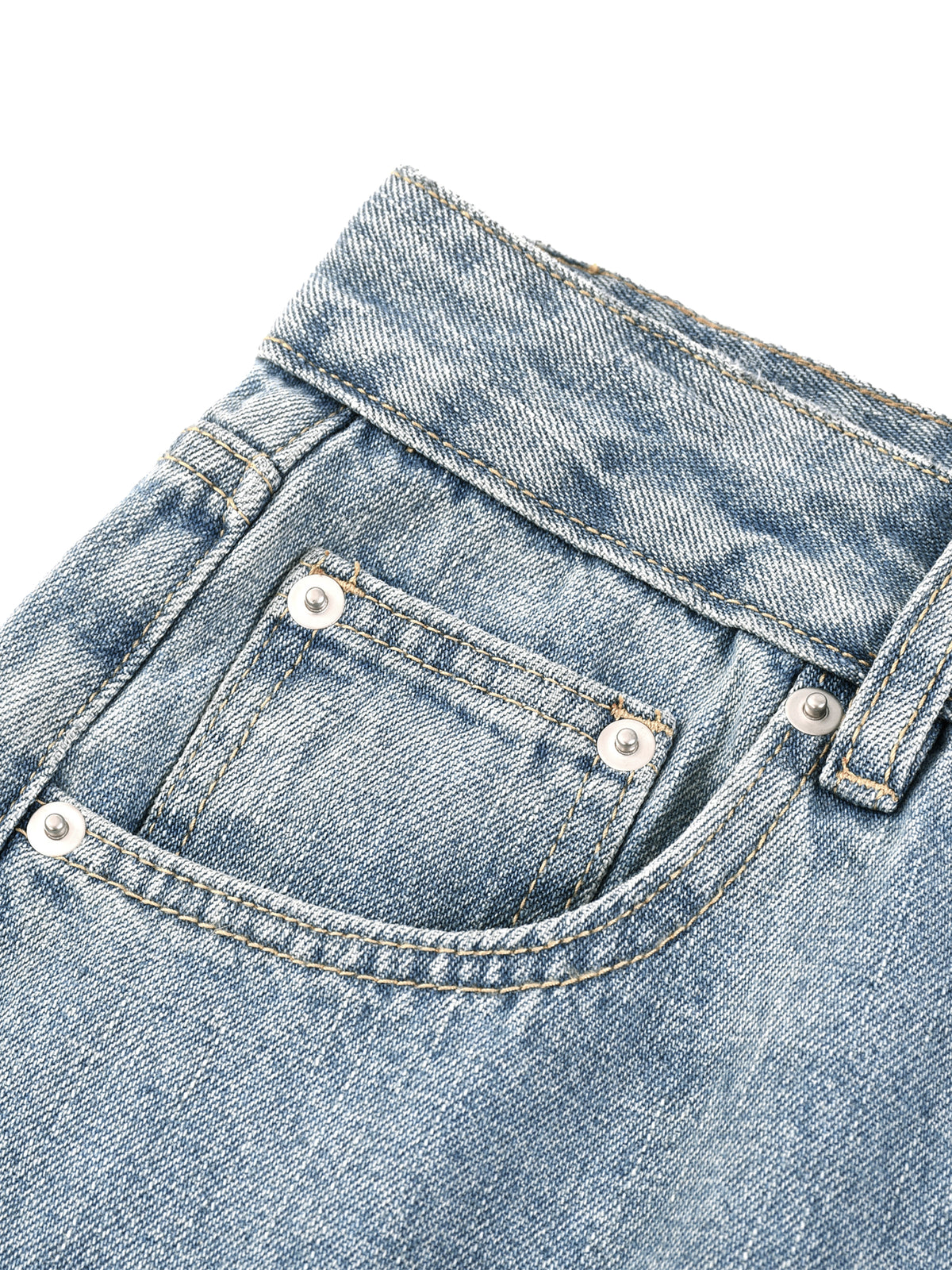 Close-up of a blue denim pocket with stitching details on a white background
