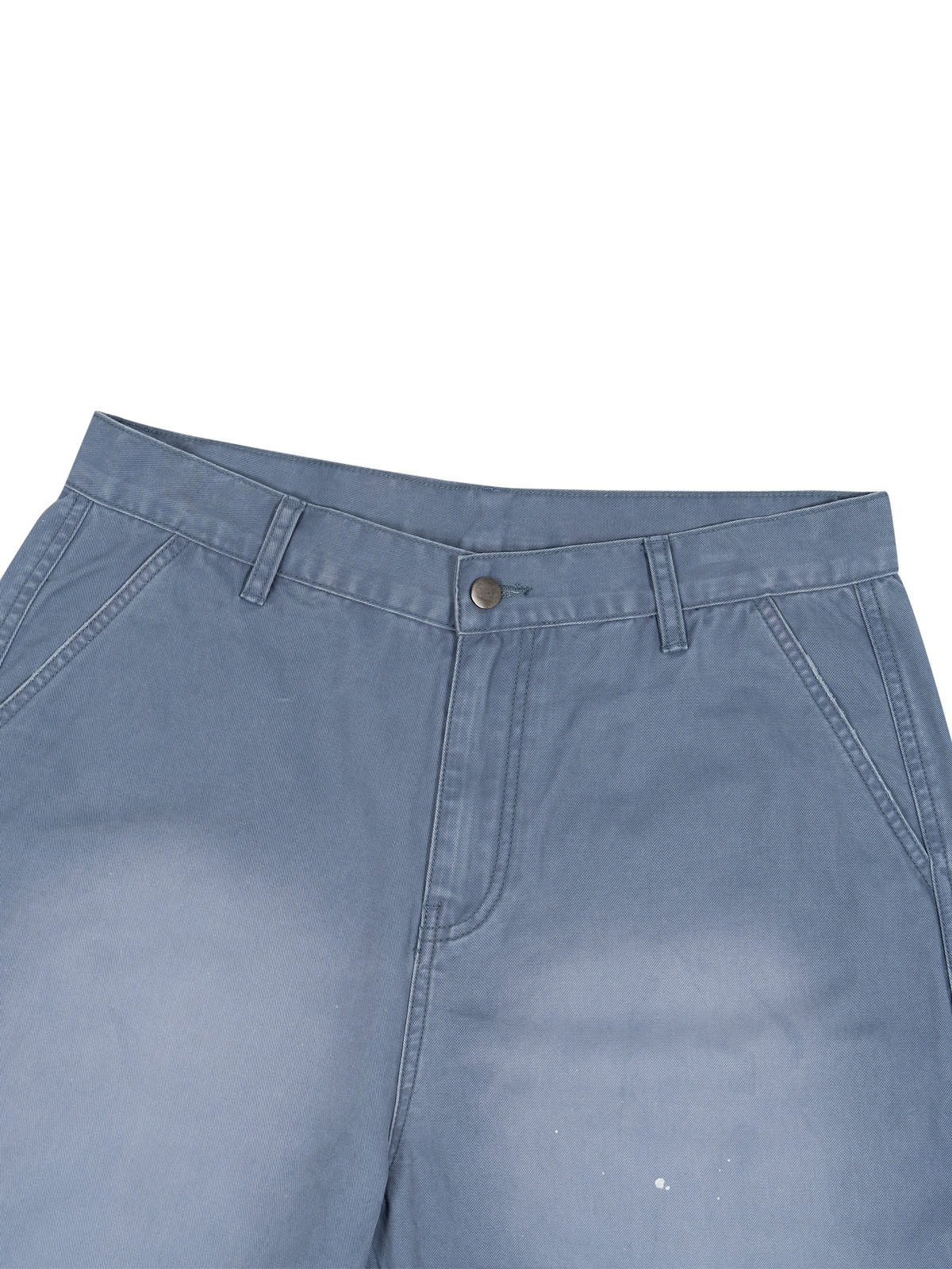 Close-up of the waistband and front pockets of light blue denim pants on a white background.