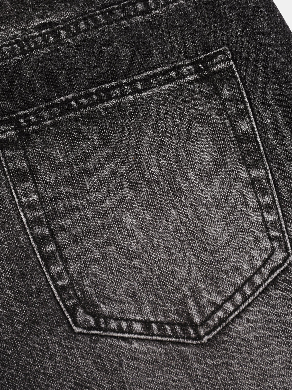 Close-up of a dark gray washed denim back pocket with visible stitching and fabric texture.