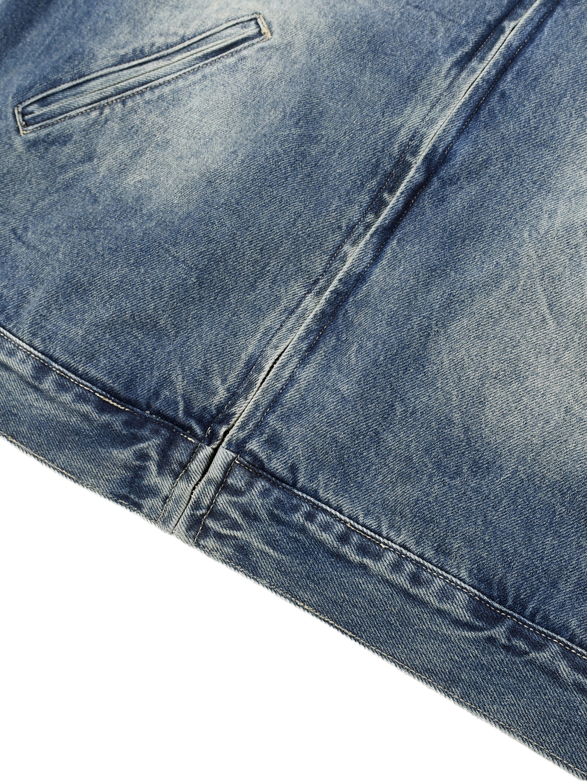 Close-up of a blue denim fabric with a pocket detail on a white background