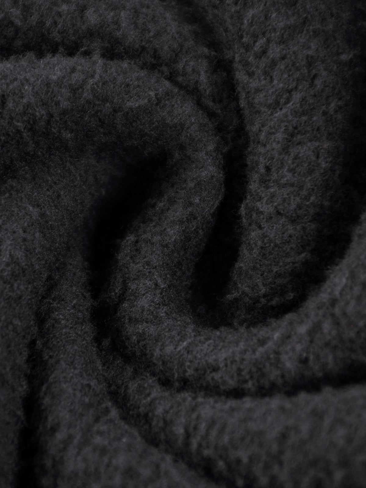 Close-up of dark gray fabric with a textured pattern