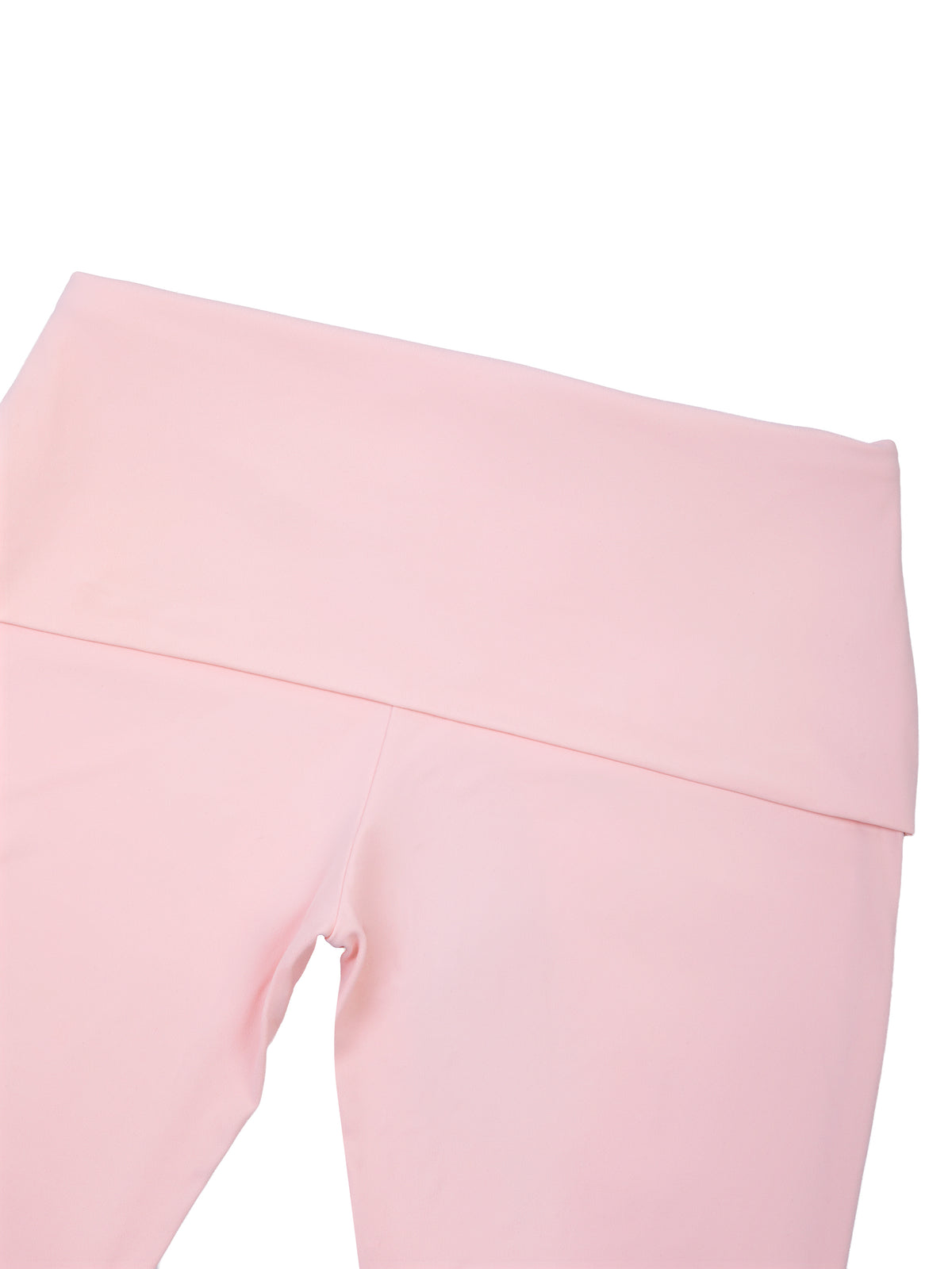 A close-up of light pink leggings showing the high-waisted waistband and upper leg area against a plain white background.
