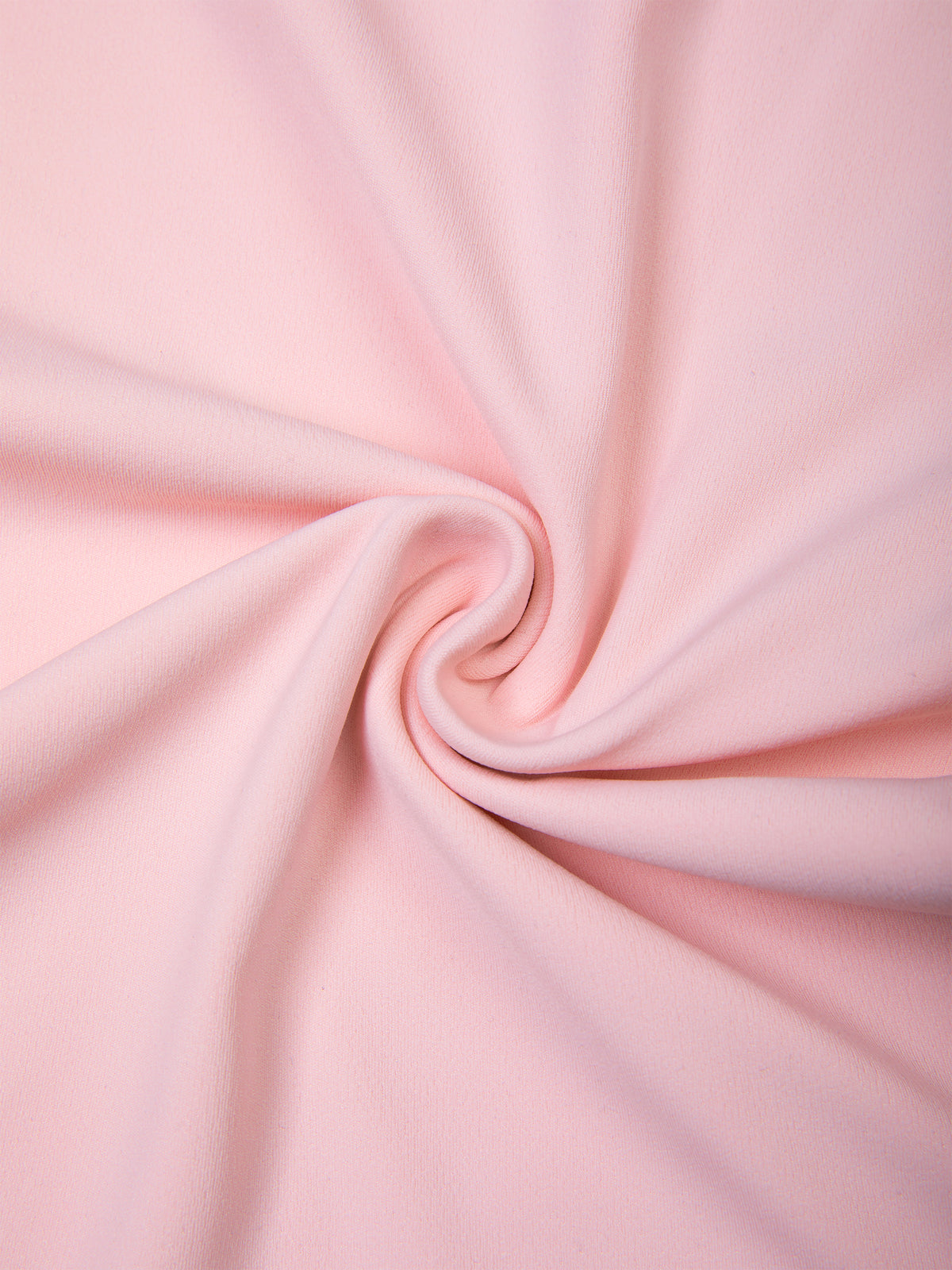 A close-up of soft pink fabric arranged in a spiral drape, showing the material's smooth texture and color.