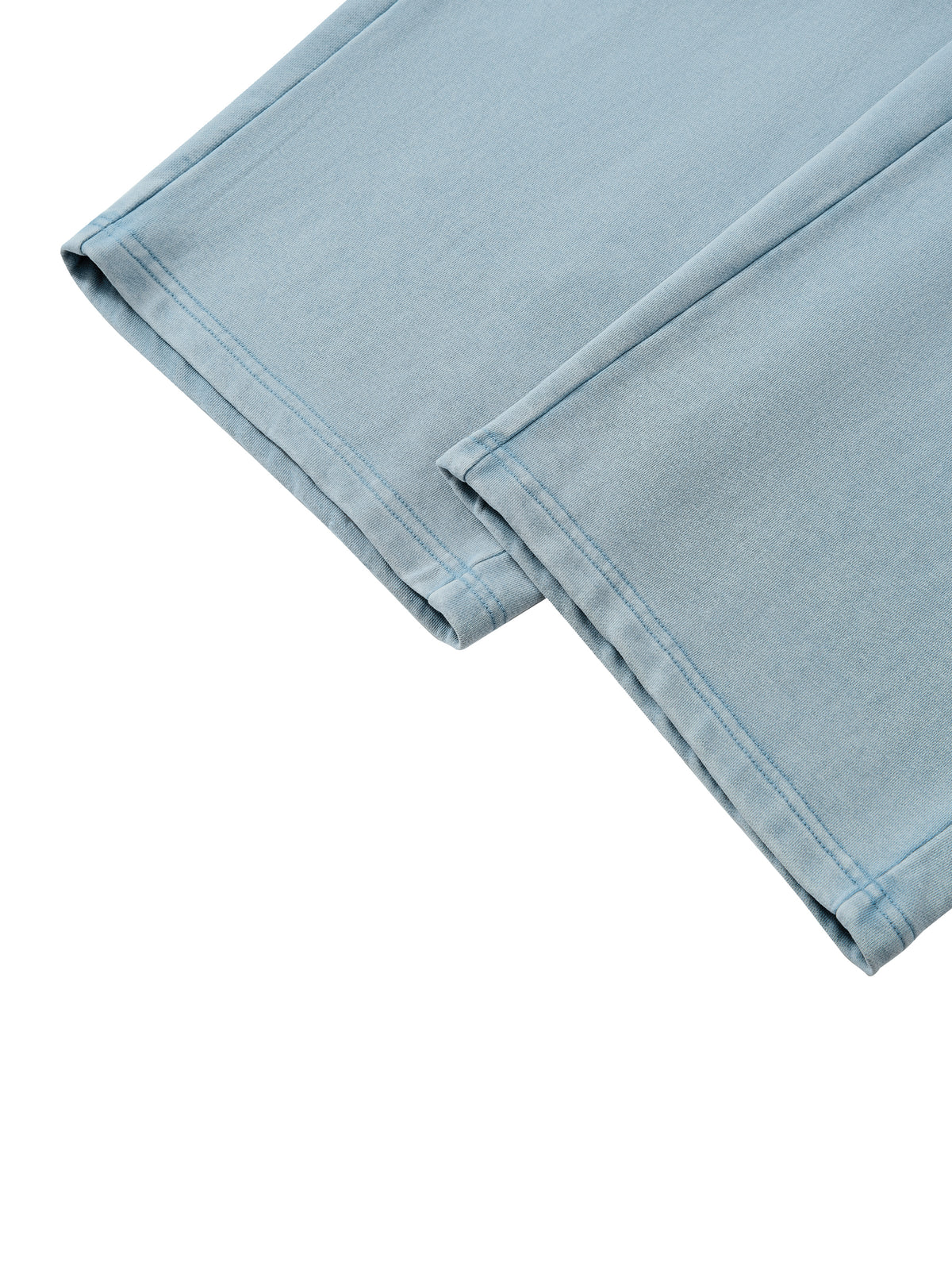 A close-up of light blue denim fabric showing the texture and double-stitched hem detail, set against a plain white background.