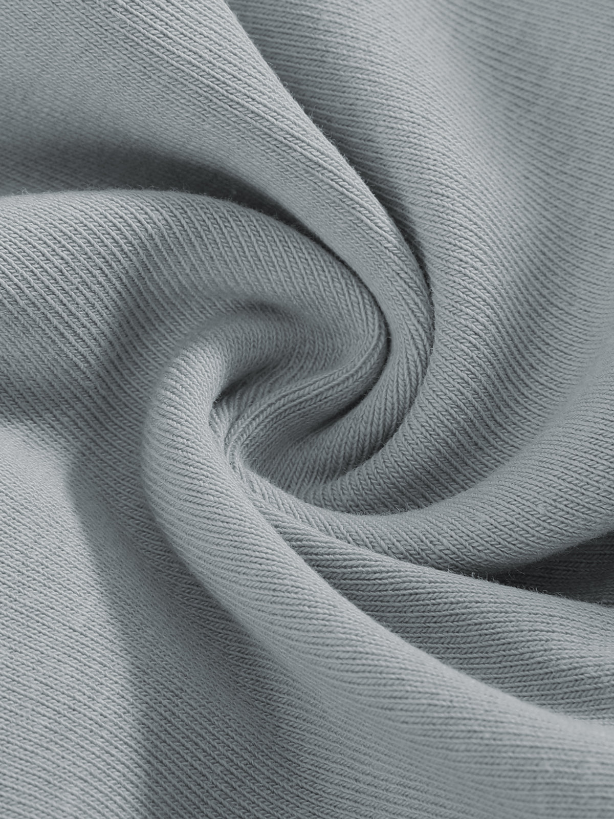 A close-up of light gray ribbed knit fabric arranged in a spiral drape, showing the texture and color of the material.