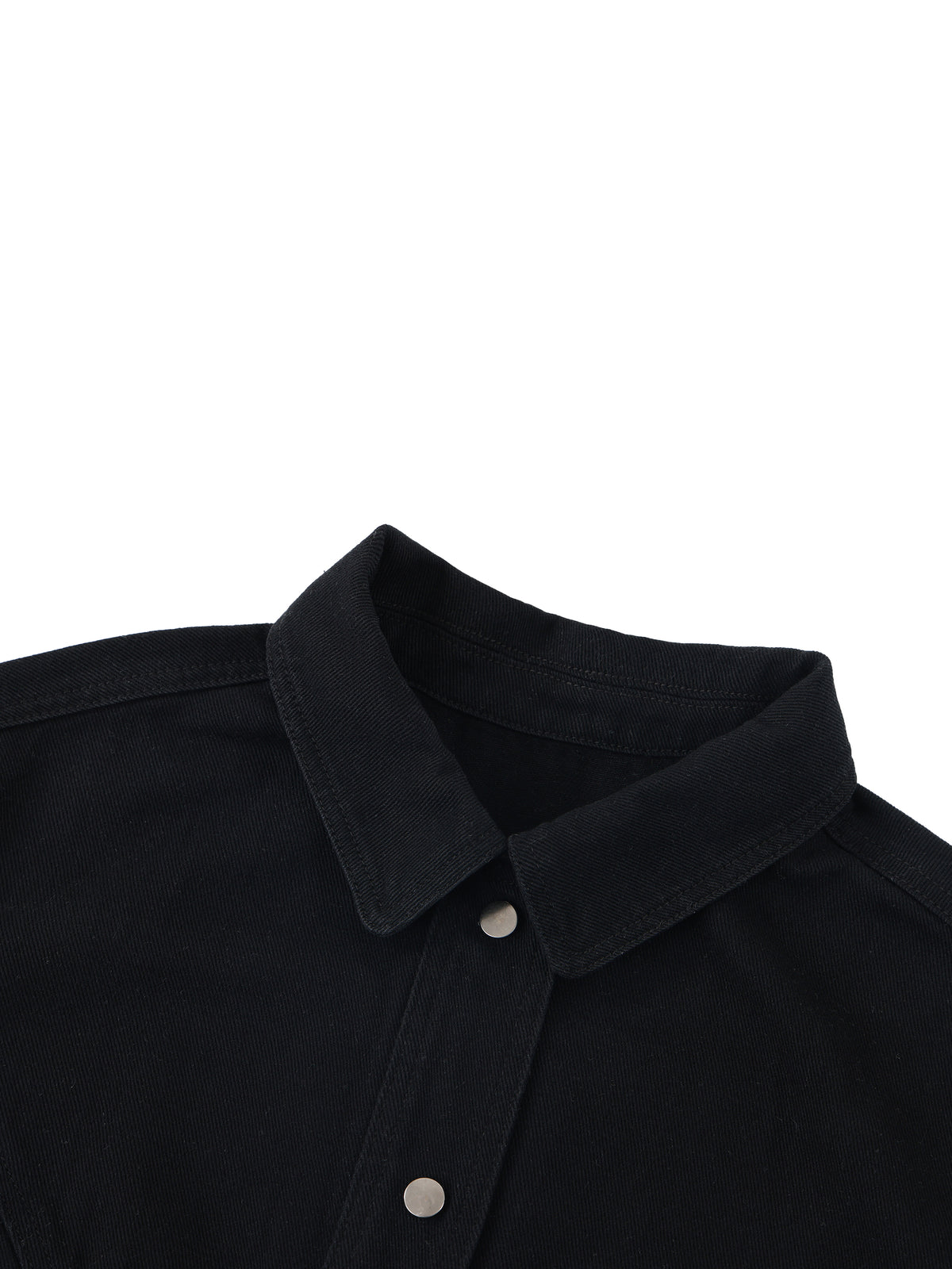 Close-up of a black button-down shirt collar with silver metal buttons on a plain white background.