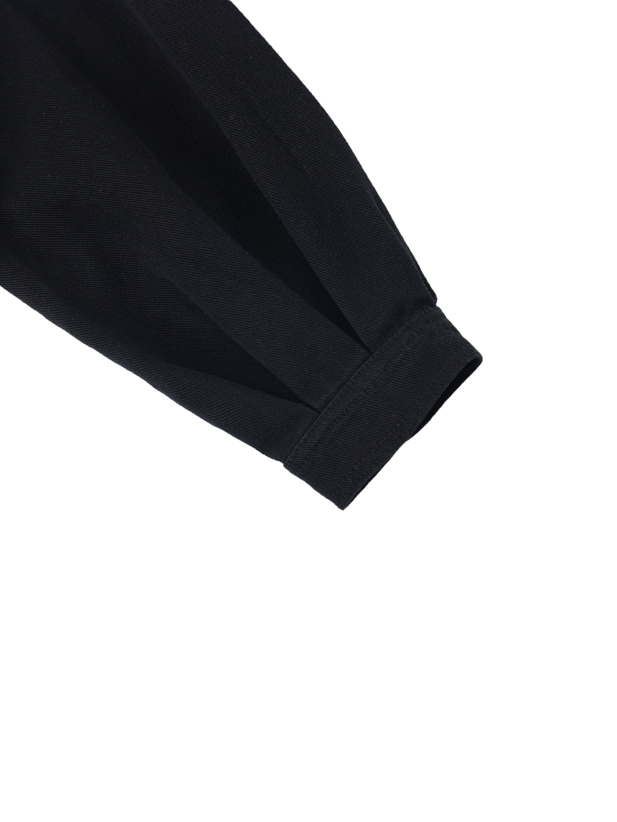 Close-up detail of a black fabric sleeve or cuff with a ribbed elastic band, shown against a plain white background.